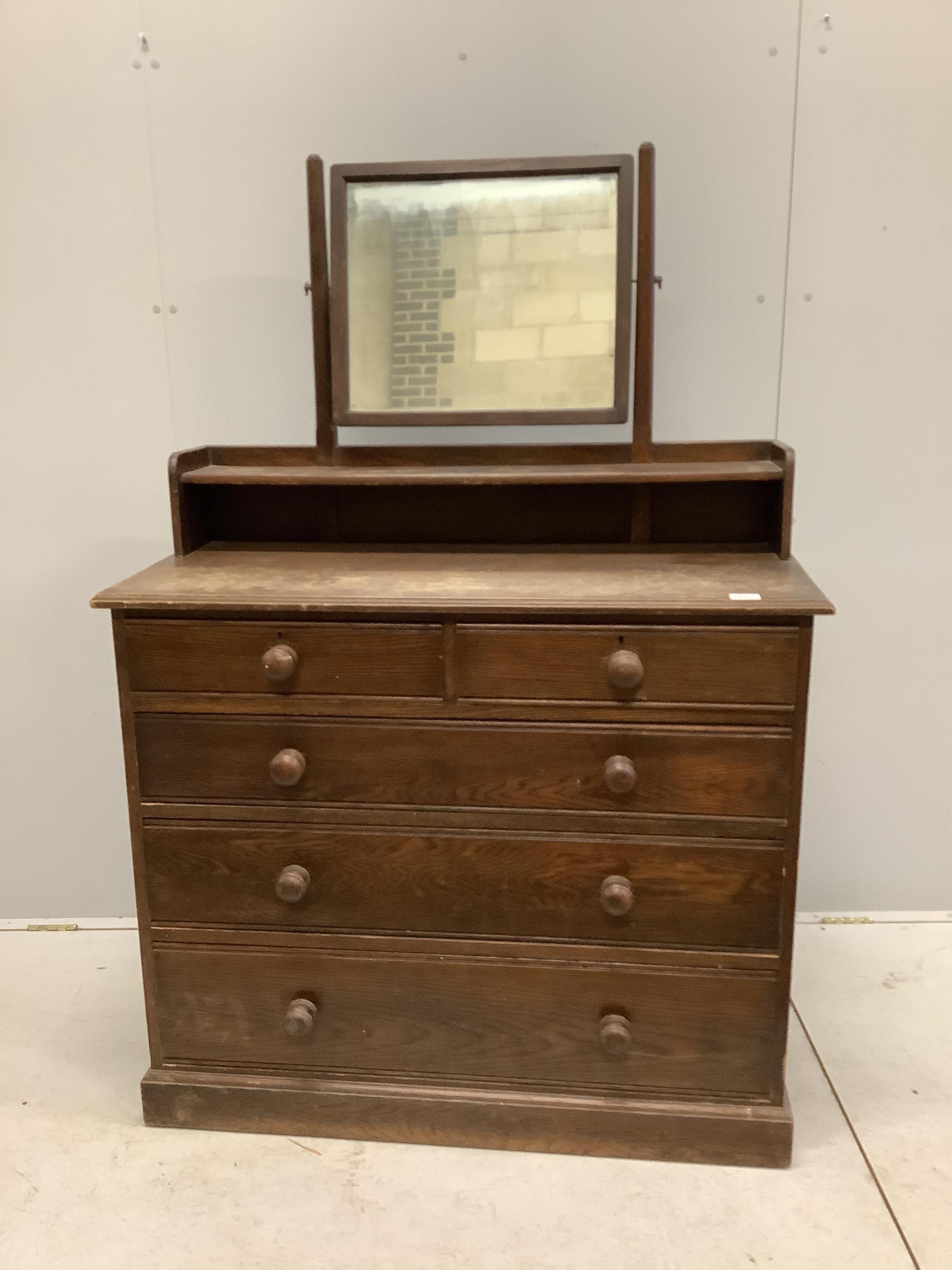 An early 20th century oak dressing chest, width 107cm, depth 49cm, height 155cm. Condition - poor